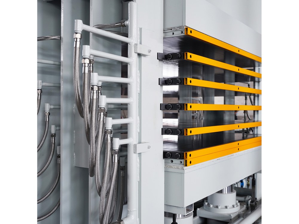 Multi-layer hot press installed in the workshop, with the safety rails in front of the platens
