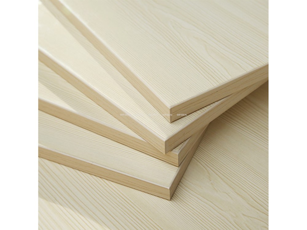 Stack of panels with edge tape applied flush to the faces, showing a finished banded edge